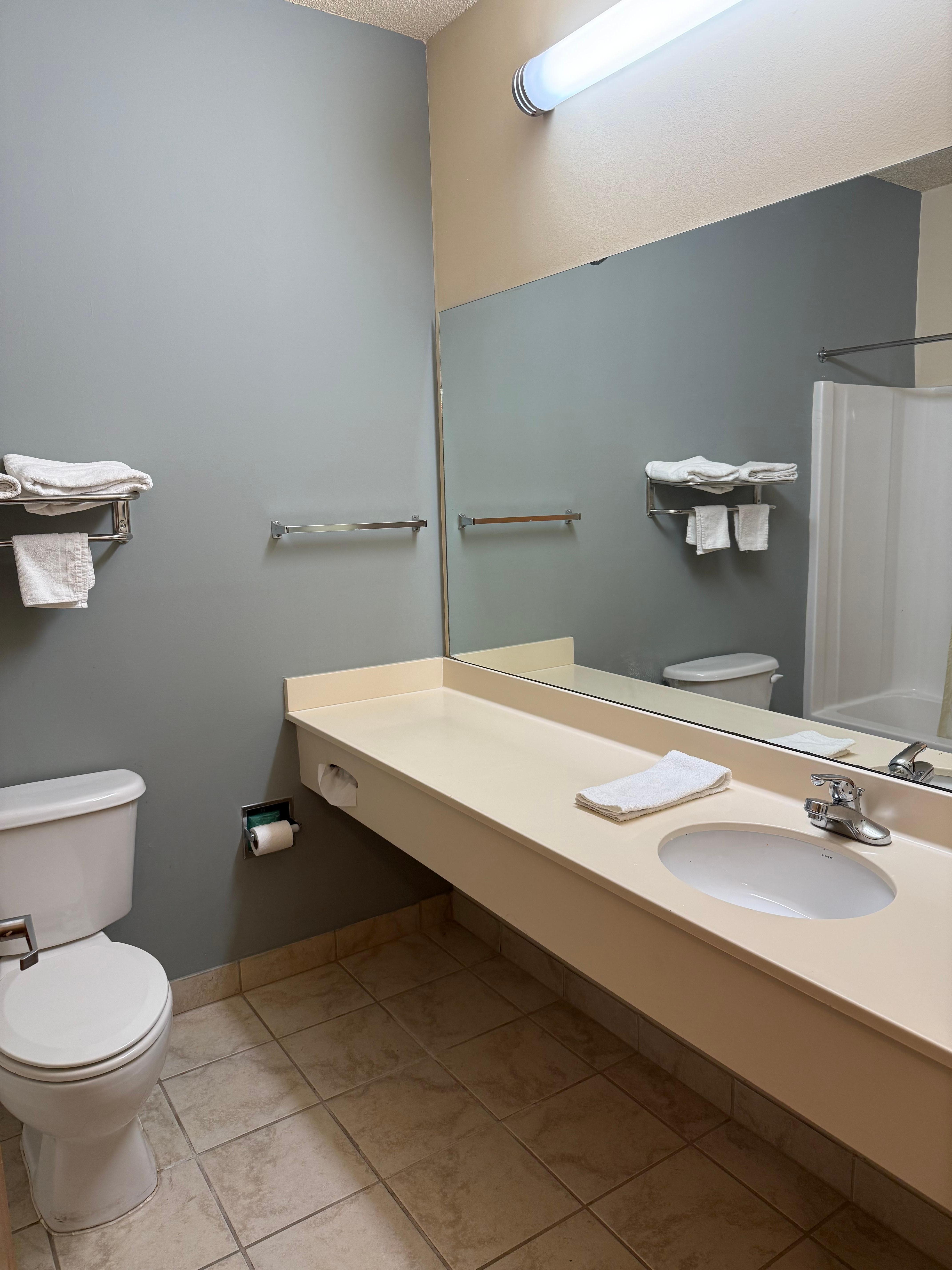 Clean bathroom but cigarette burns on sink.
Strong, hot water (+)