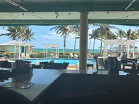 View of pool & ocean from restaurant bar