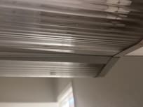 Bathroom light full of bugs, filthy and falling down.