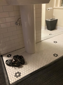 Love the floor tiling paired with modern sink, shower toilet.