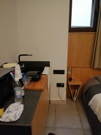 Kitchen area right next to the bed made room feel cramped.