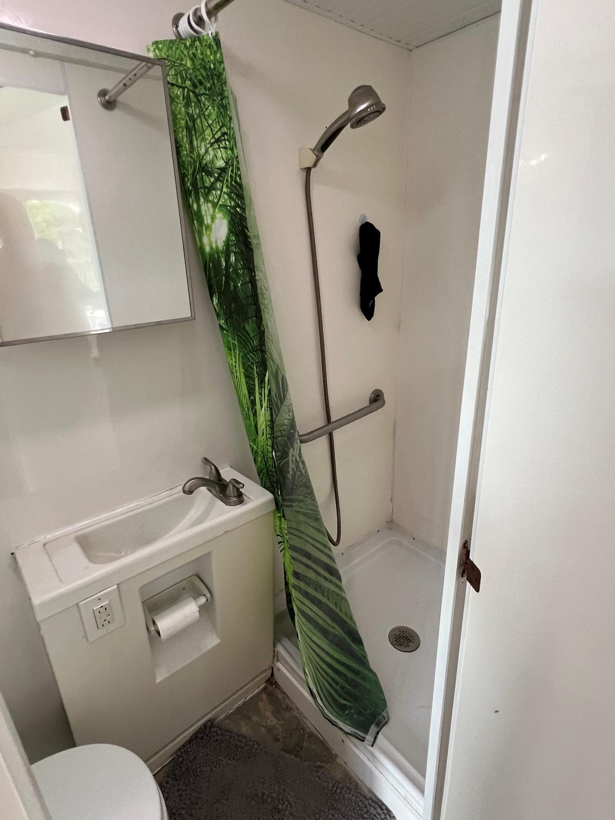 A one bathroom with shower 