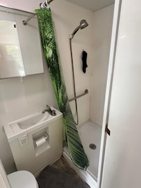 A one bathroom with shower