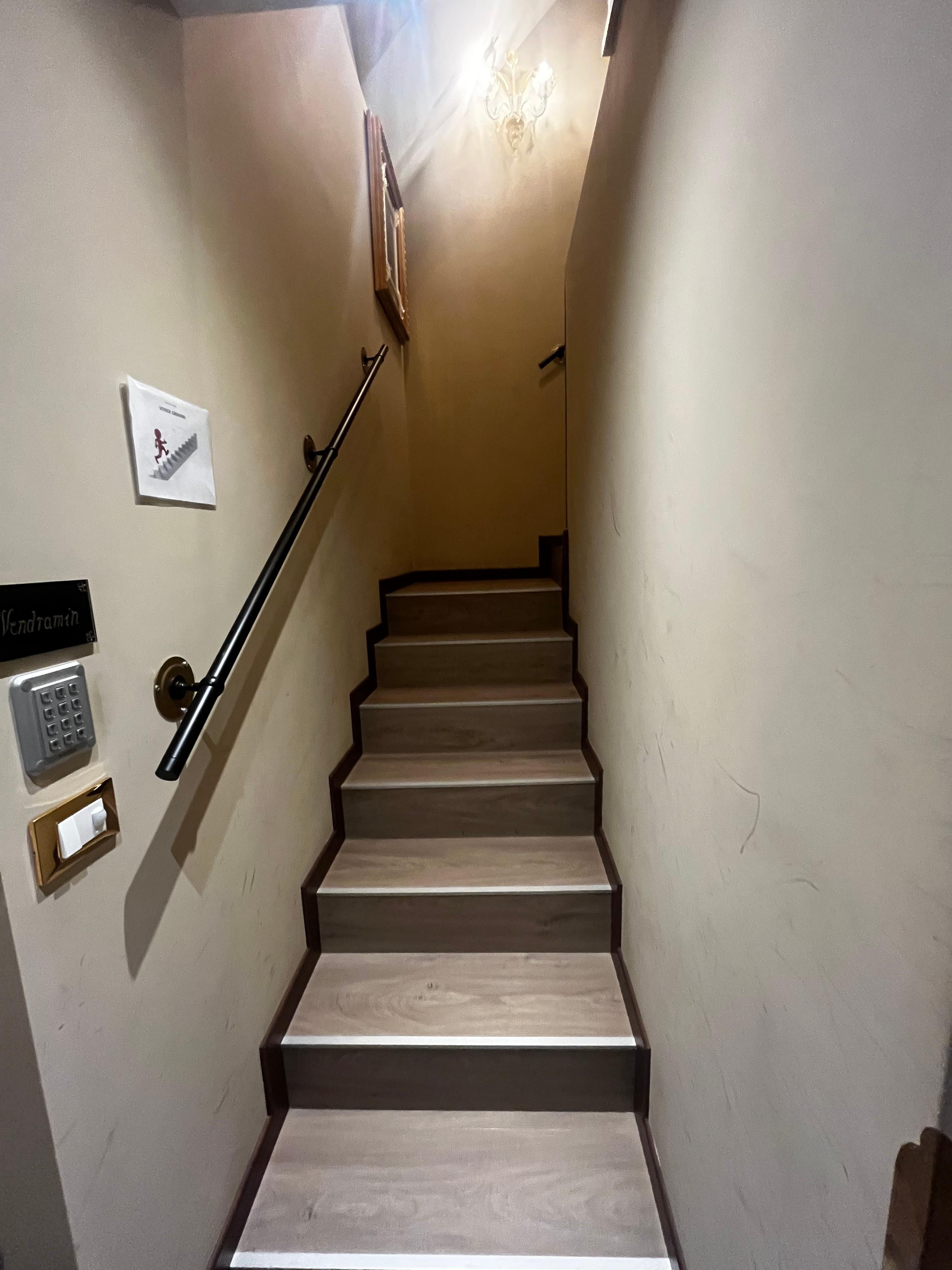 The staircase leading to the rooms is right next to the entrance door of the room.