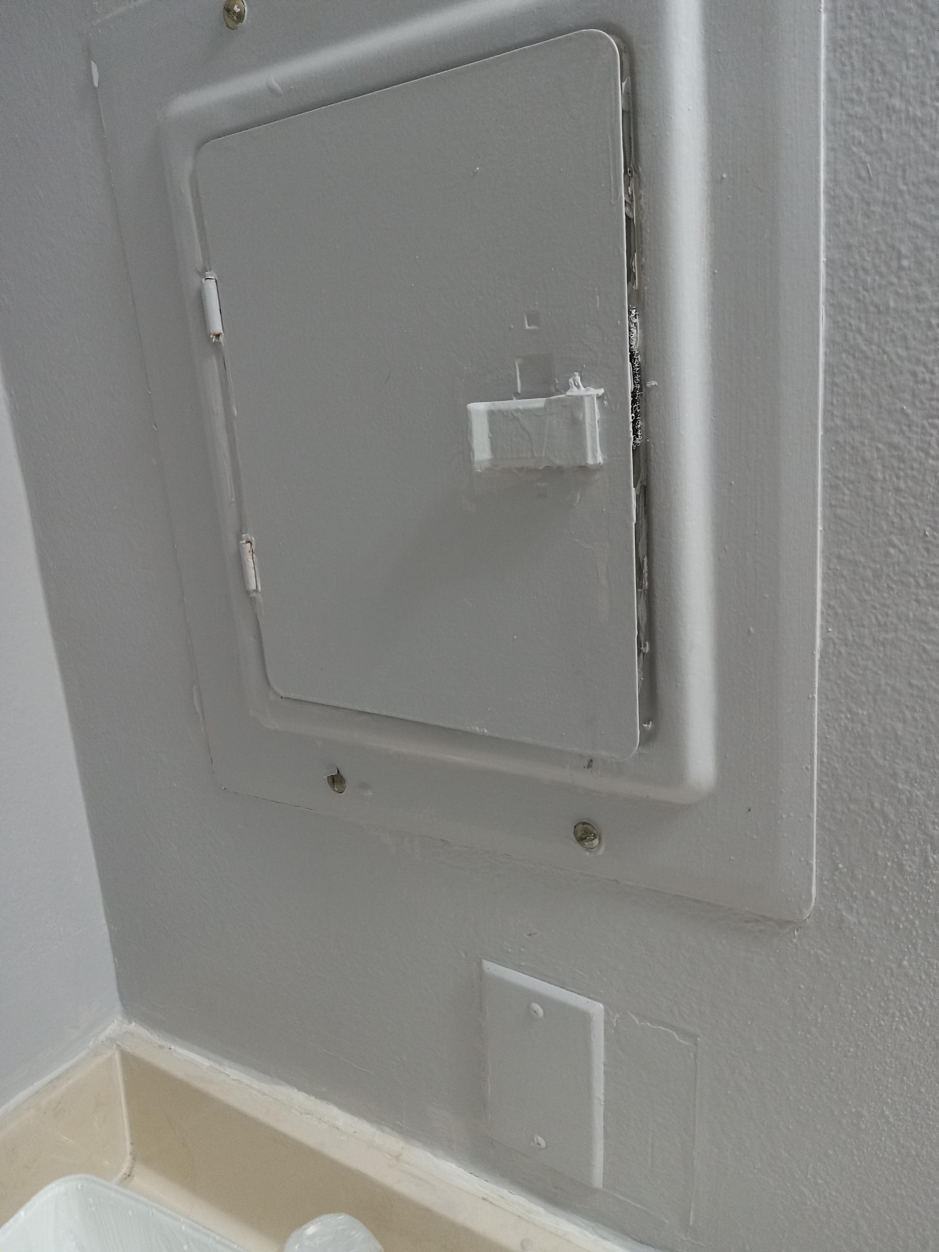 Rusty fuse box above sink