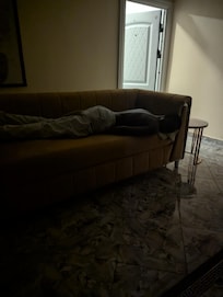 My husband laying on couch and wasn't offered my covers