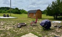 back yard, additional patio in foreground.3 beach chairs were like the one shown