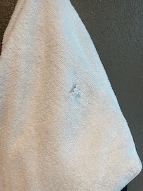 Hole in towel.