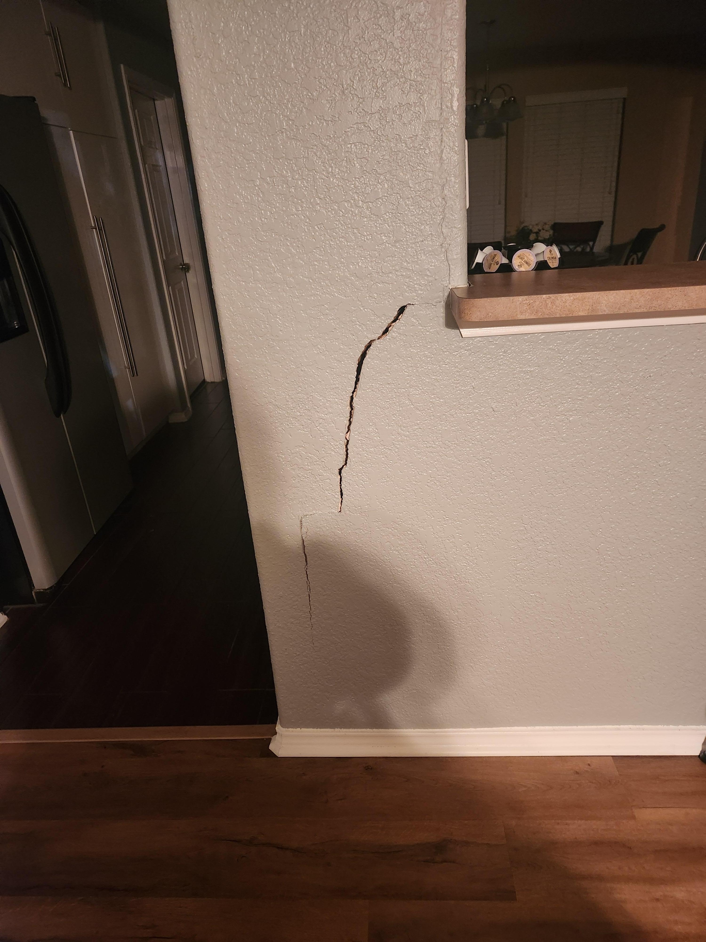 Large crack in the living room headed to the kitchen.