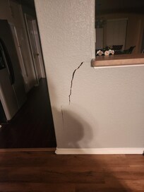 Large crack in the living room headed to the kitchen.