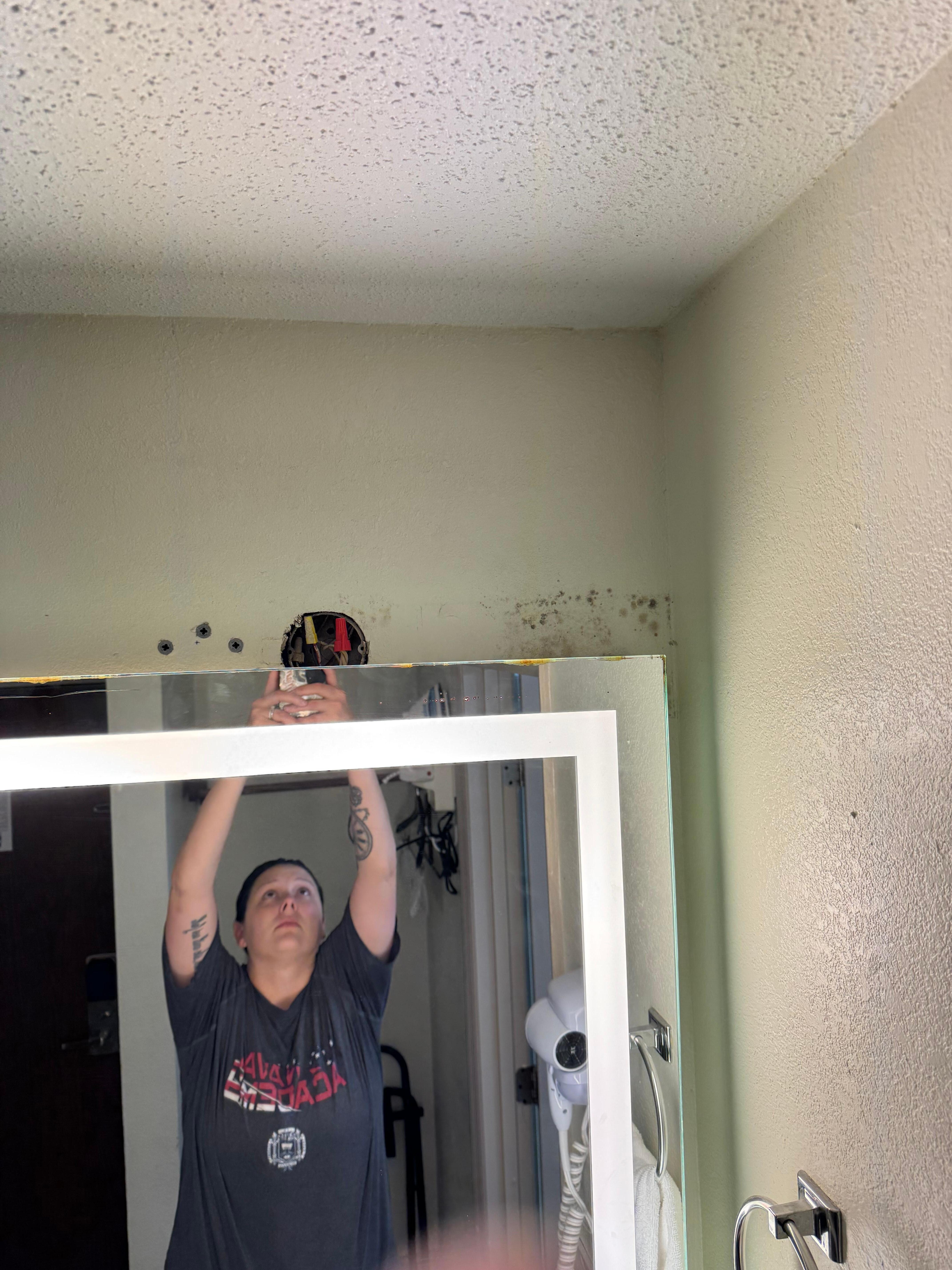 Above the mirror in the bathroom 