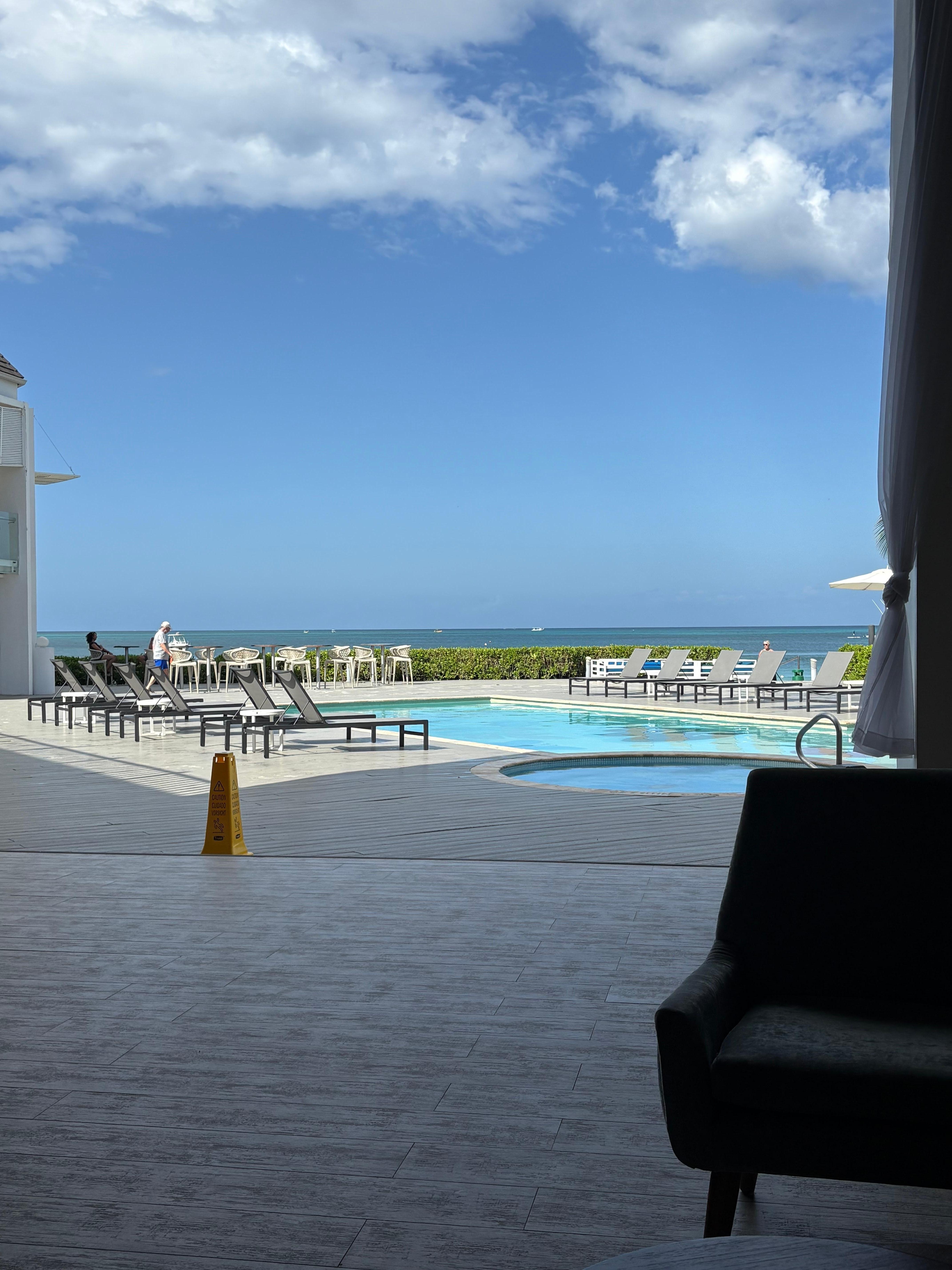 View of the pool and hot tub from the hotel foyer.