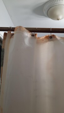 Shower curtain poles were rusty and liner was discolored.