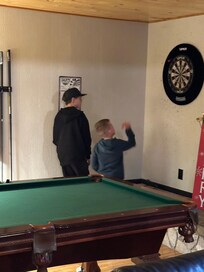 Pool table and dart board for extra fun