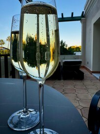 Cava on our outdoor patio overlooking the golden tower and river