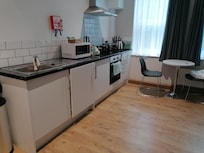 Kitchen area, washing machine in a cupboard.