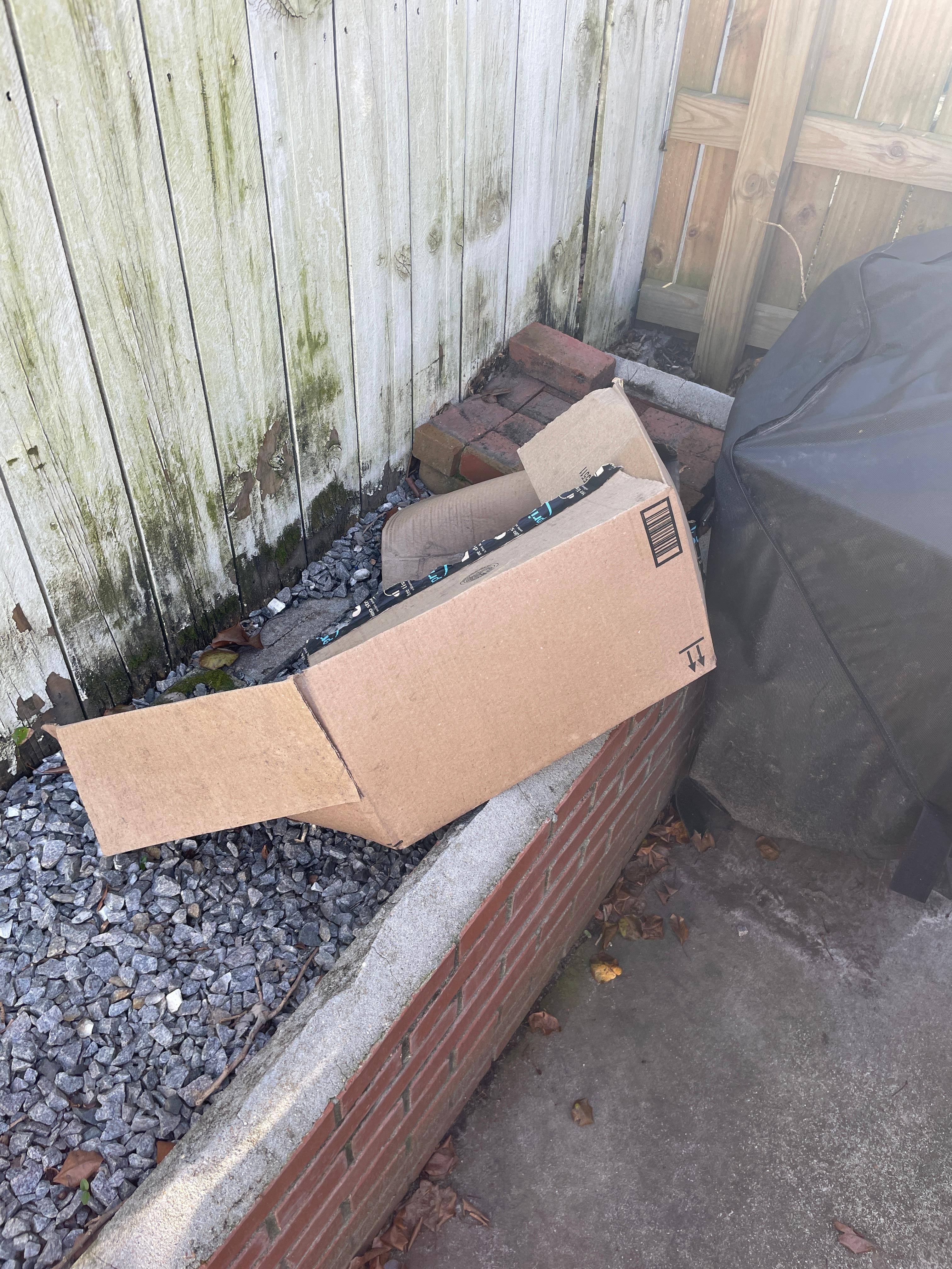 1 of 2 empty boxes sitting in the bsckyard
