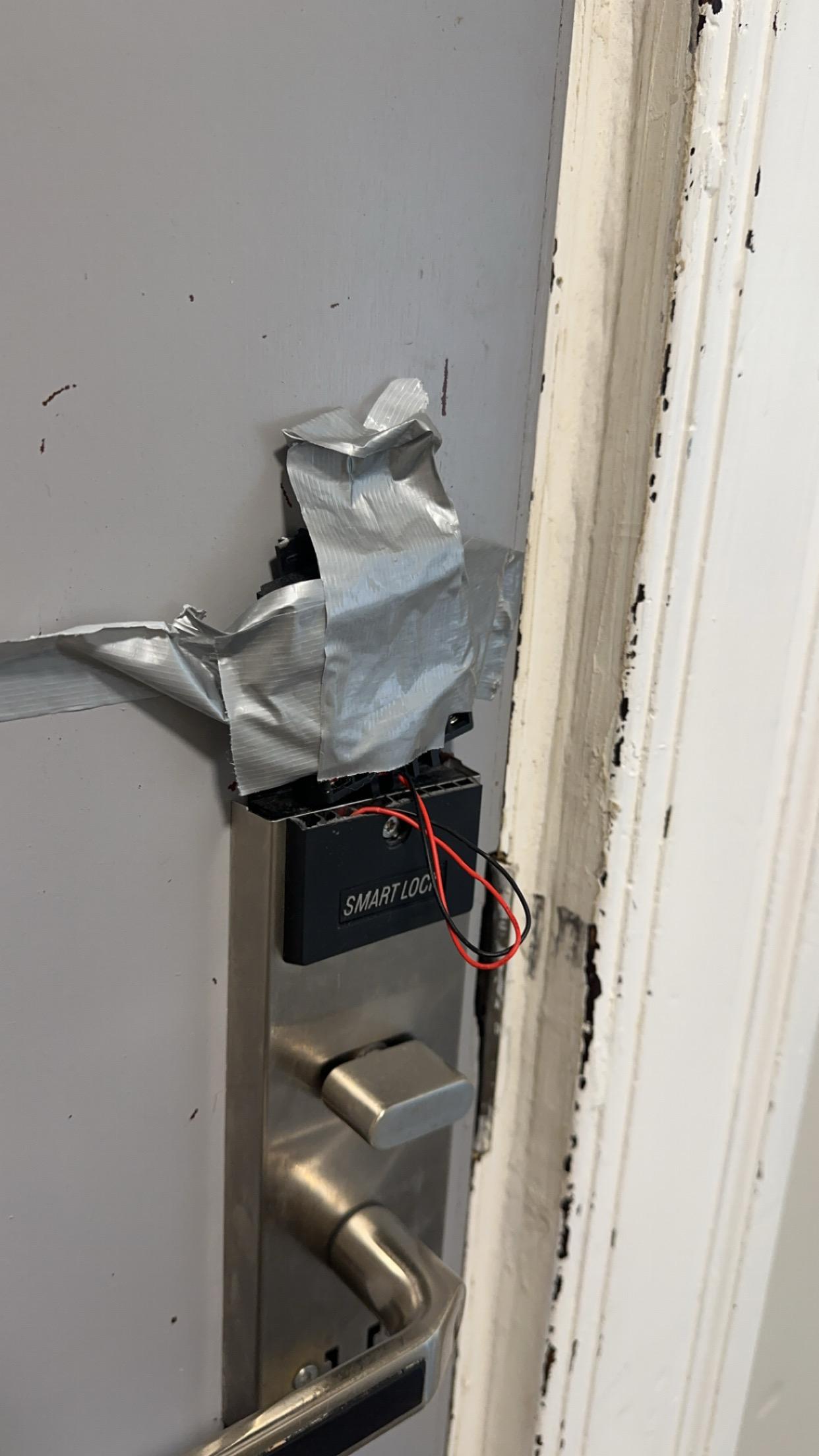 Duct tape and exposed wires on the door locking mechanism 