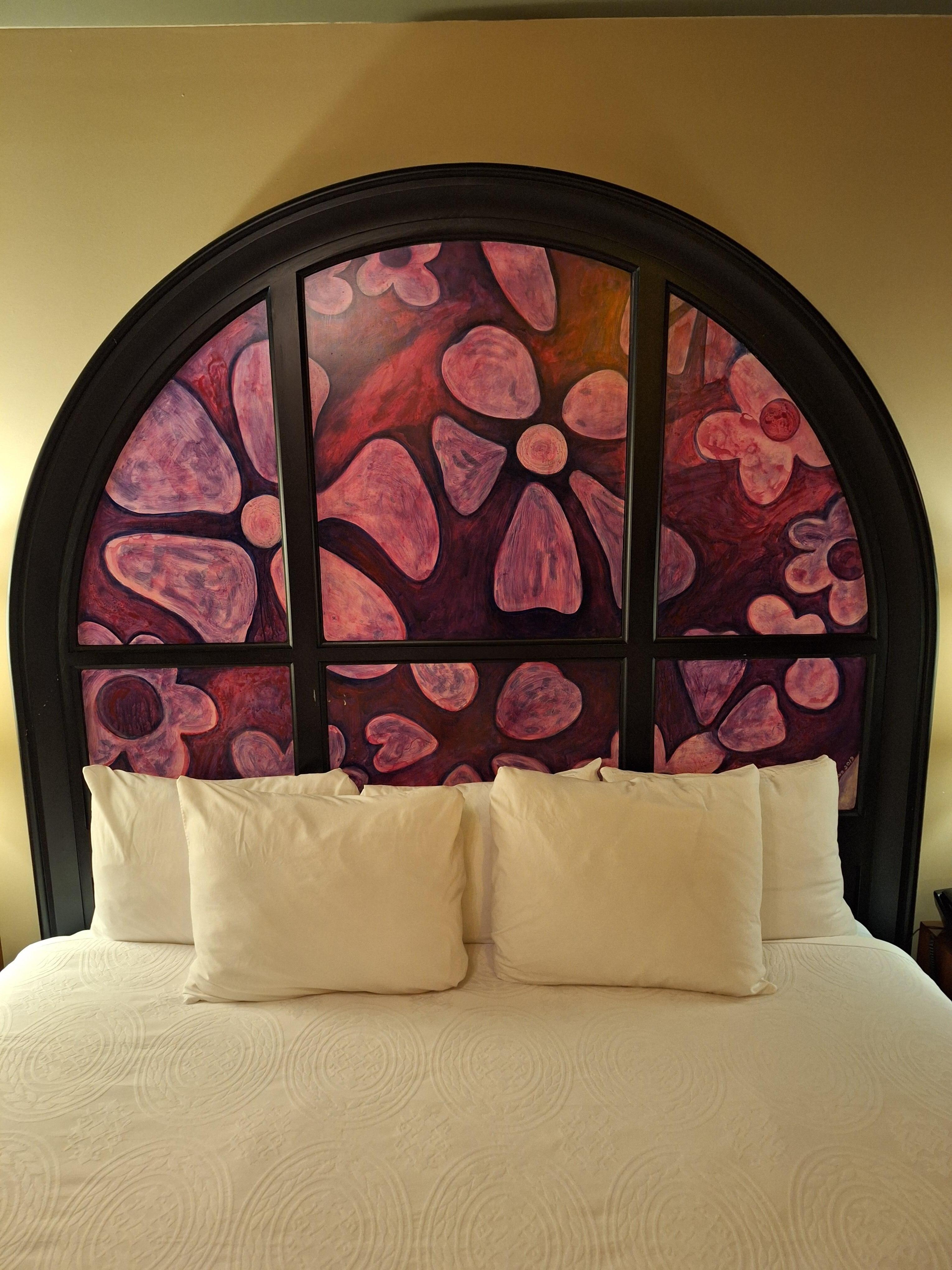 The bed in my room. The headboard in each room is painted differently.