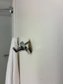 Robe hook dangling. Poor wall anchoring