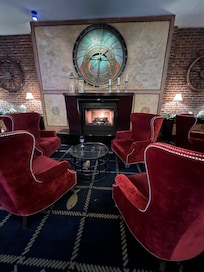 Cozy chairs by the fire.