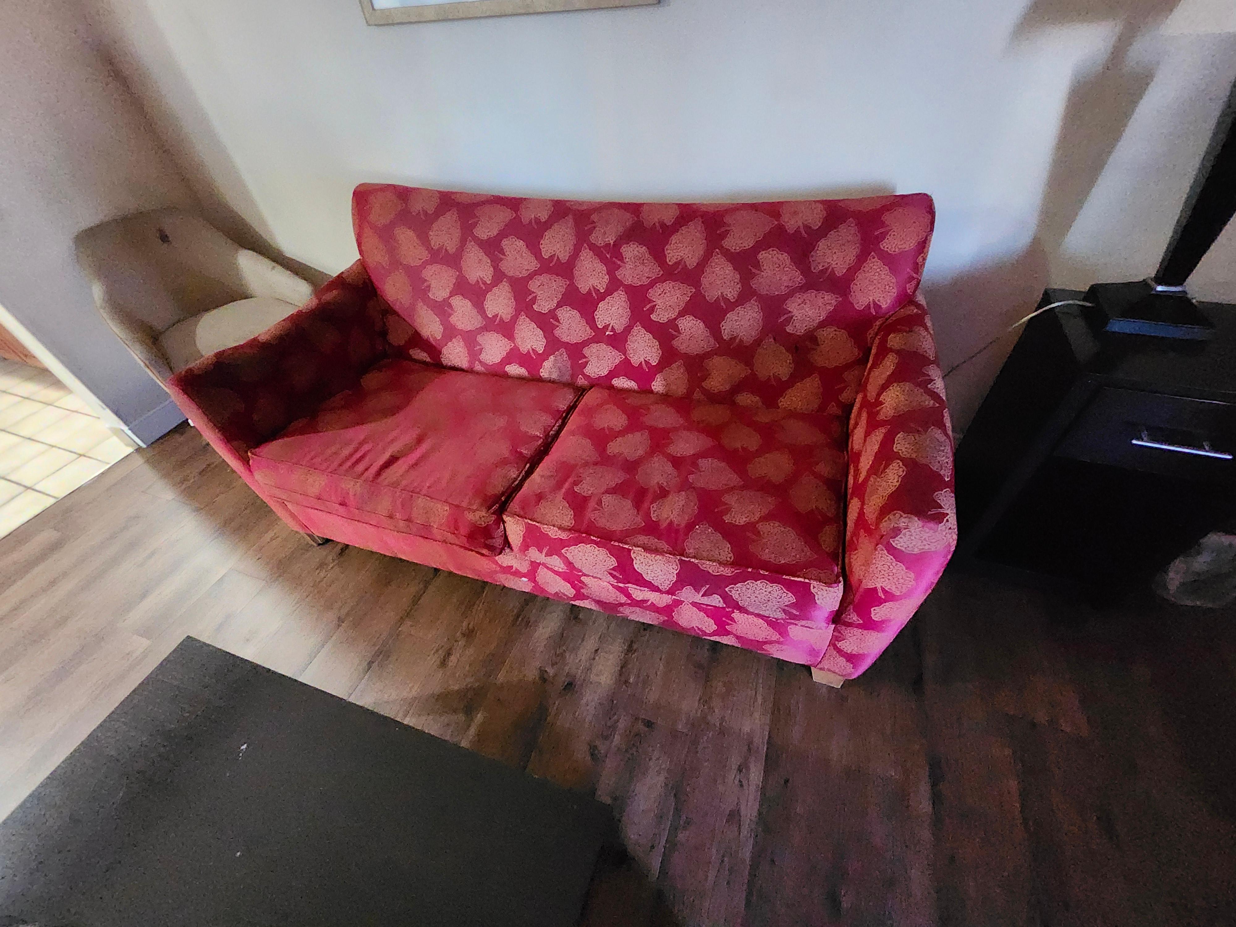 Sofa was torn, faded, and dirty.