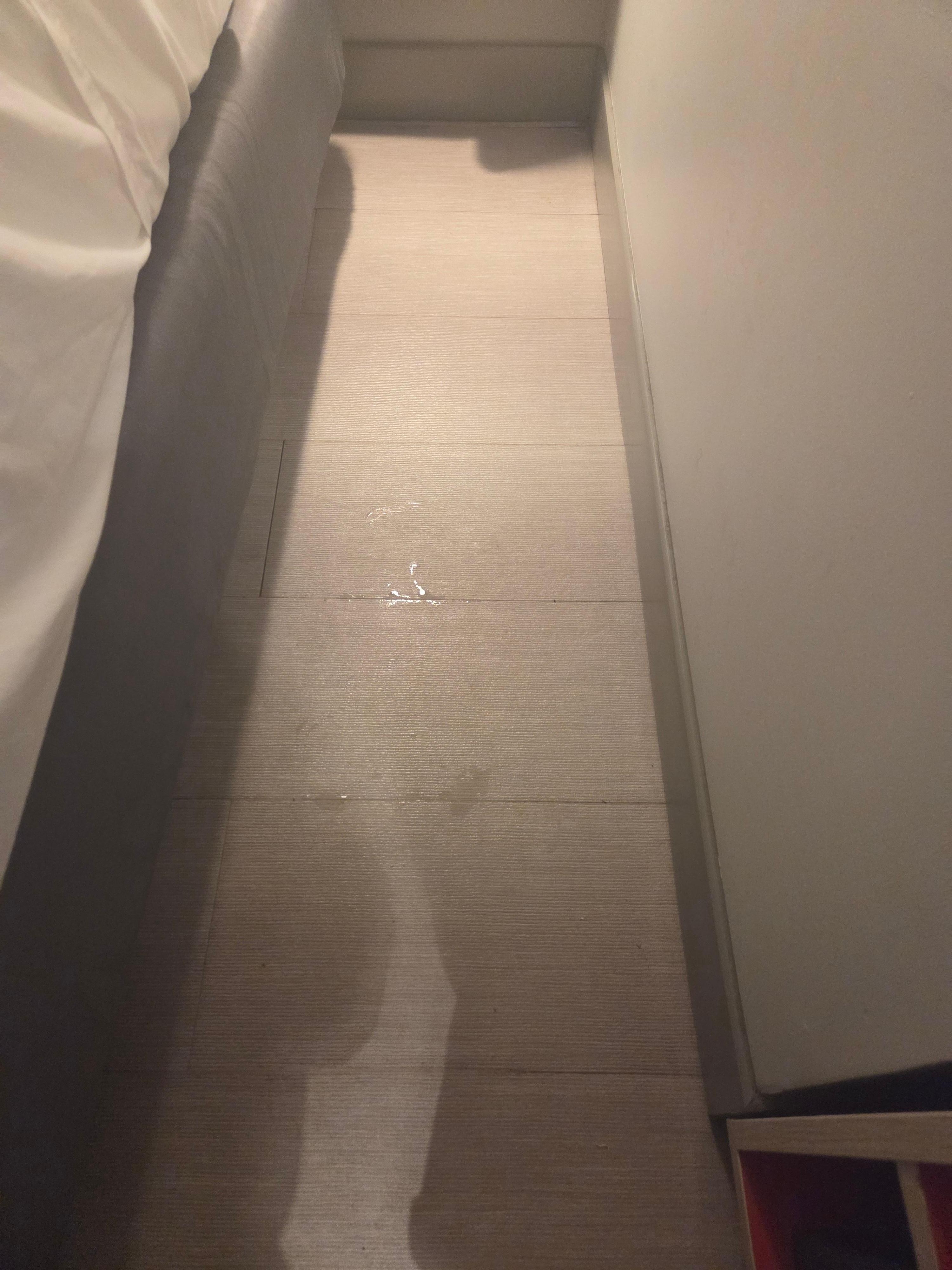 Water coming through floor tiles.