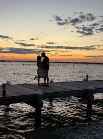 Fishing or kissing pier with a beautiful sunset.