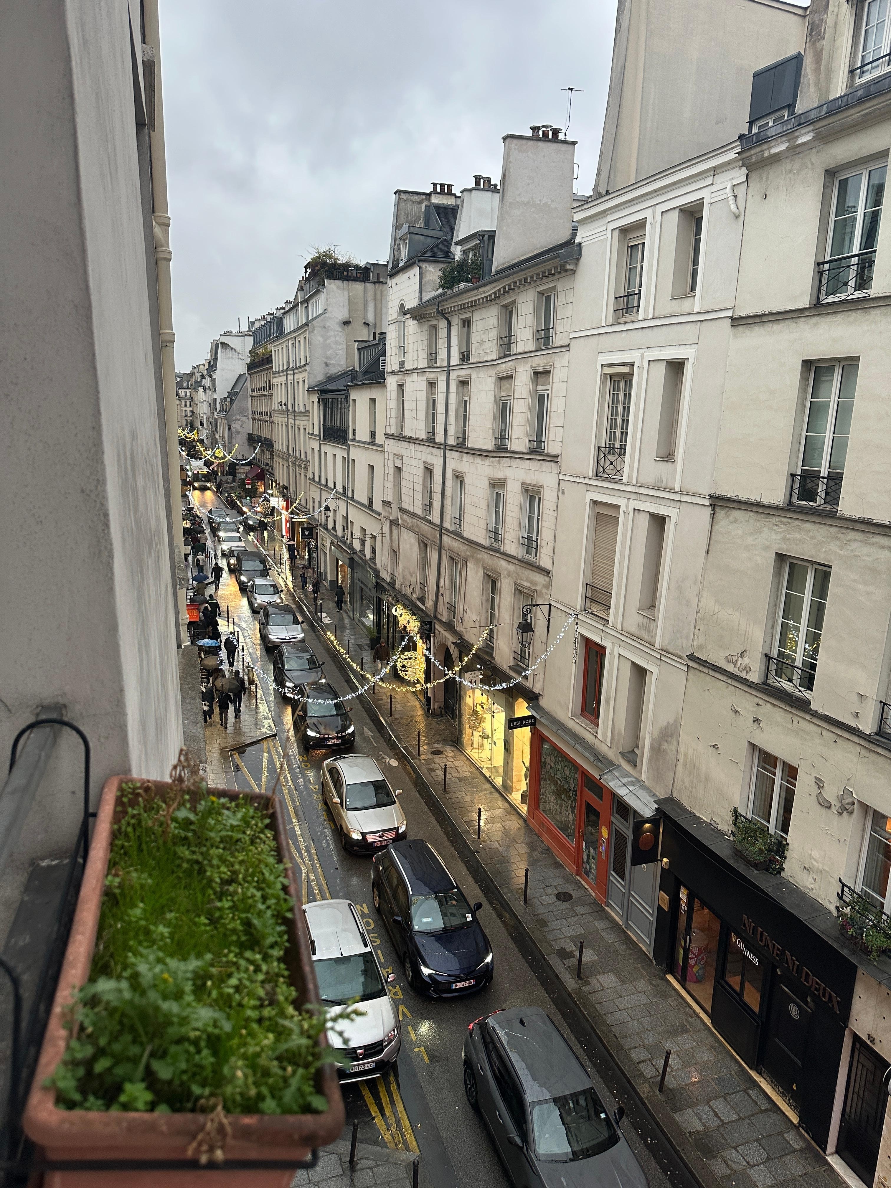 View out of the window down the street below. 