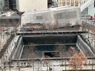 view of the 911 memorial pool, across the street is Liberty Park and Club Quarters Hotel