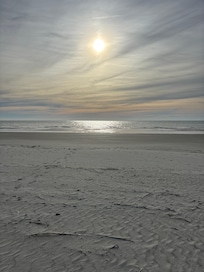 Beach walk in front of building.