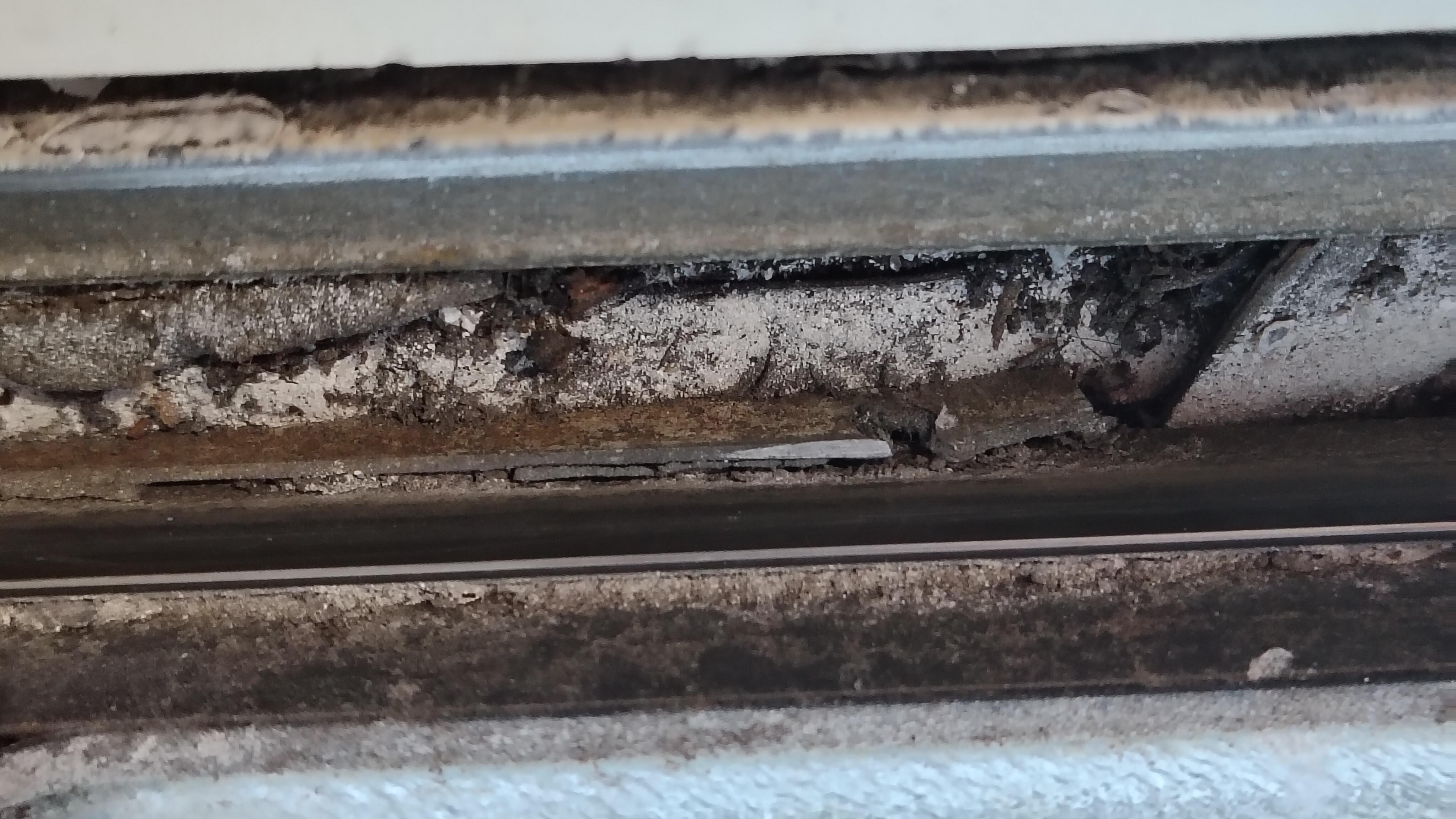 The window sill in the moldy bathroom filled with mold 