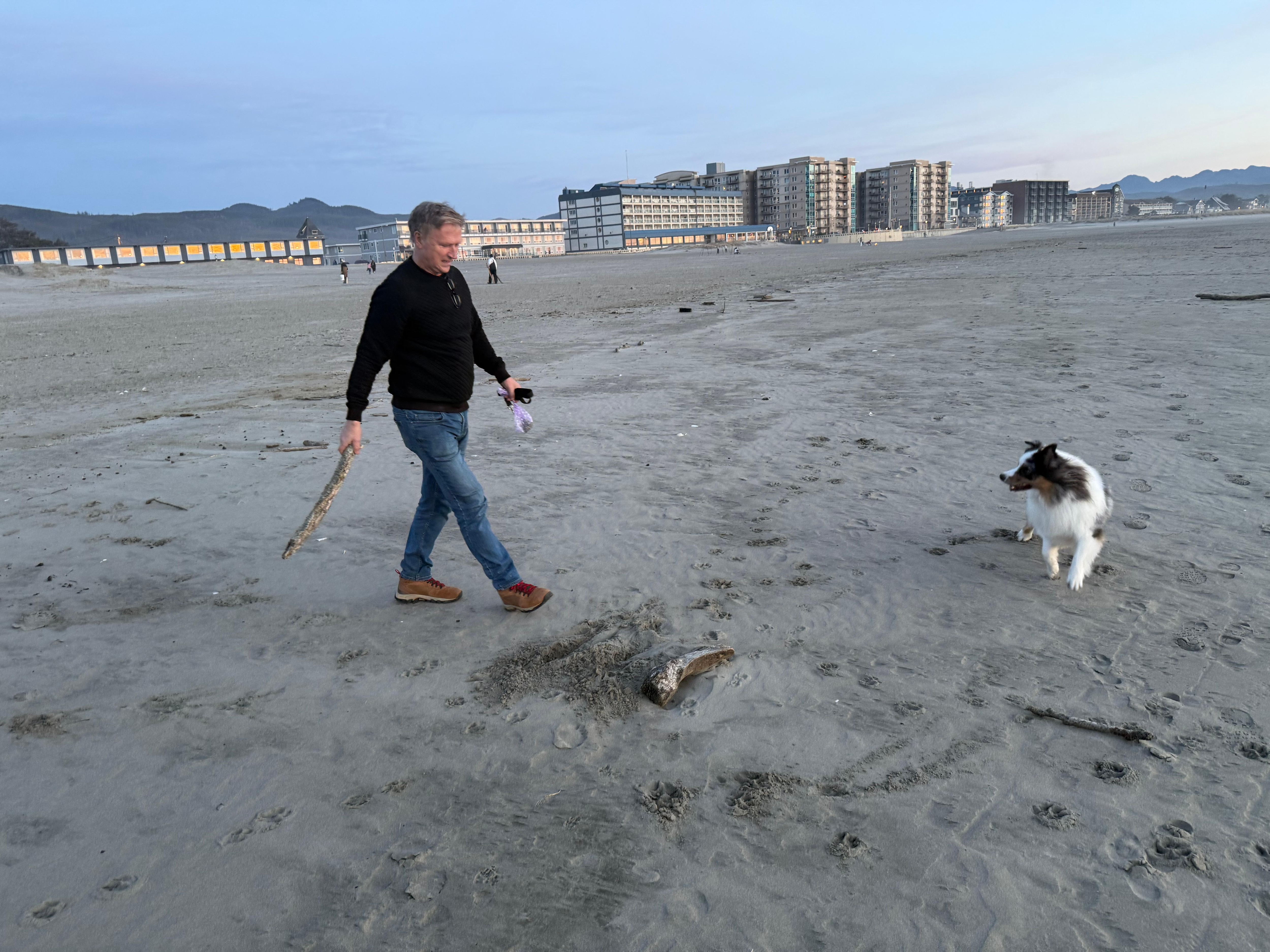 My husband and dog on the huge beach 