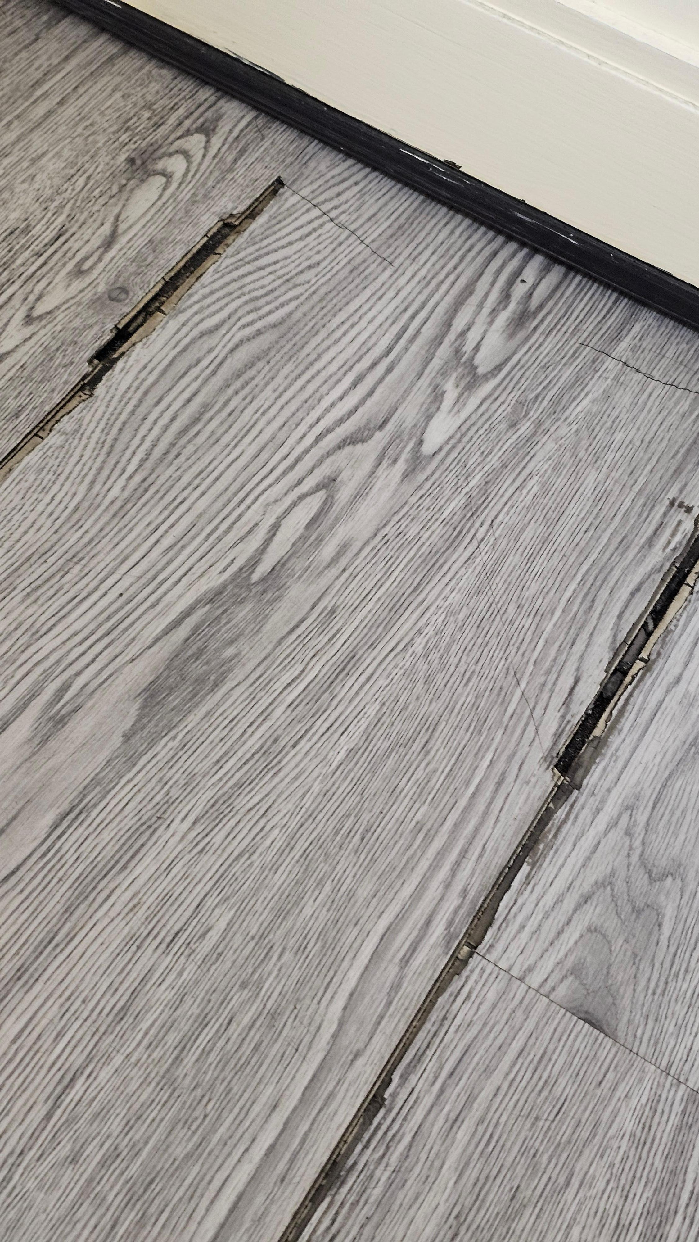 Room vinyl floor coming up all over the room.  Trip hazard & caused black dust all over floor.