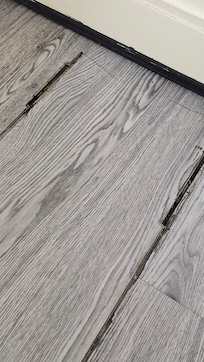 Room vinyl floor coming up all over the room.  Trip hazard & caused black dust all over floor.