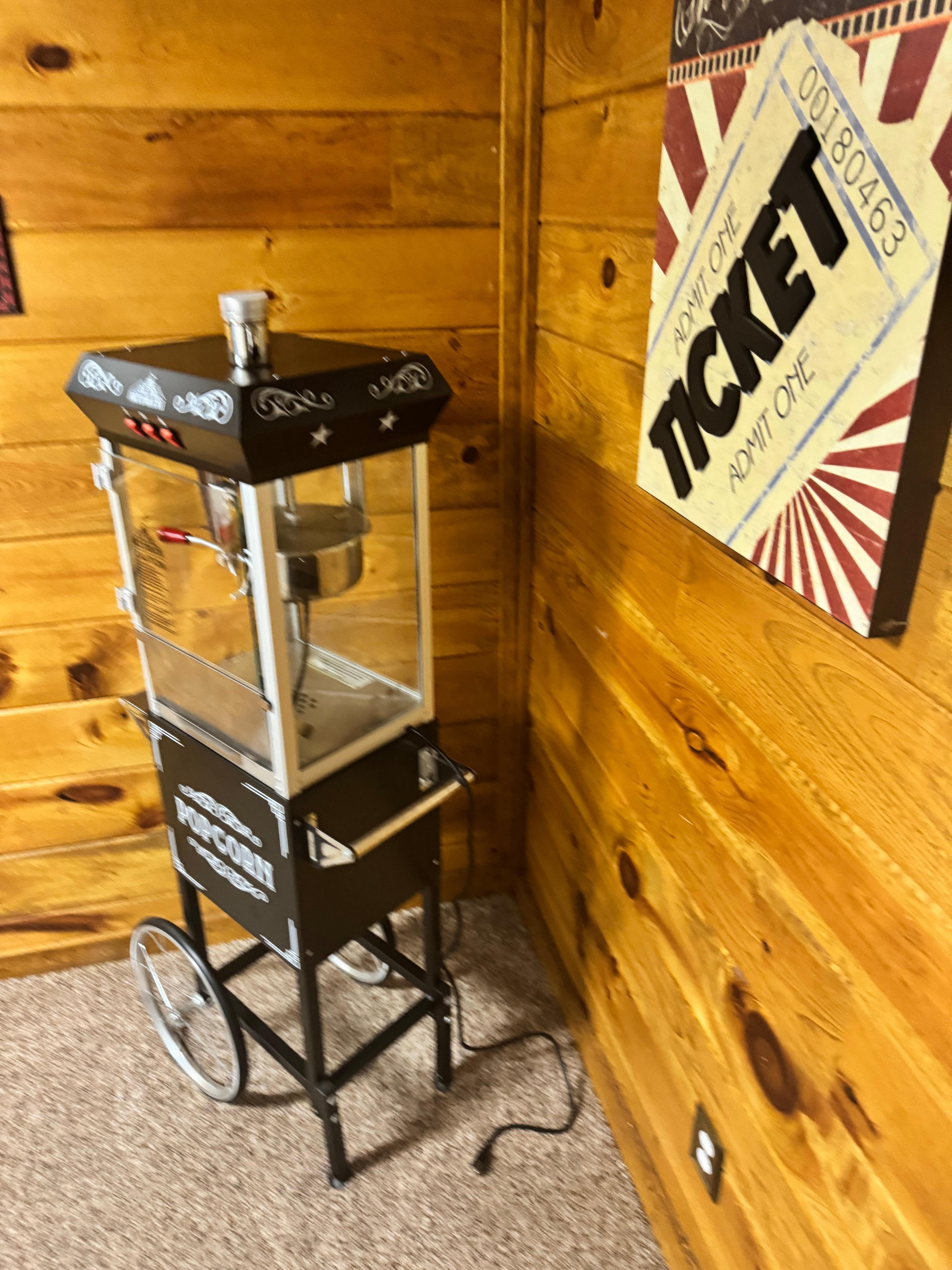 Popcorn machine in theater room.   