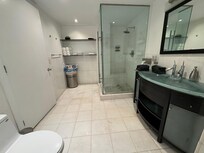 Spacious 2-way bathroom. Door to bedroom and door to living space.