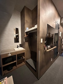 小小的空間有衣櫃和水槽櫃,有微波爐和小冰箱