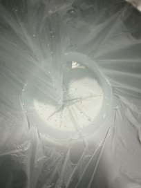 Melted ice in the liner inside of the ice bucket.