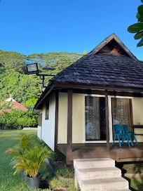 Cabin has kitchen with dining area, bedroom is large with closet and safe, deck with table and chairs is shaded