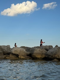 My girls fishing on the rocks on the East End Beach