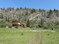 View of the cabin and adjacent cliffs