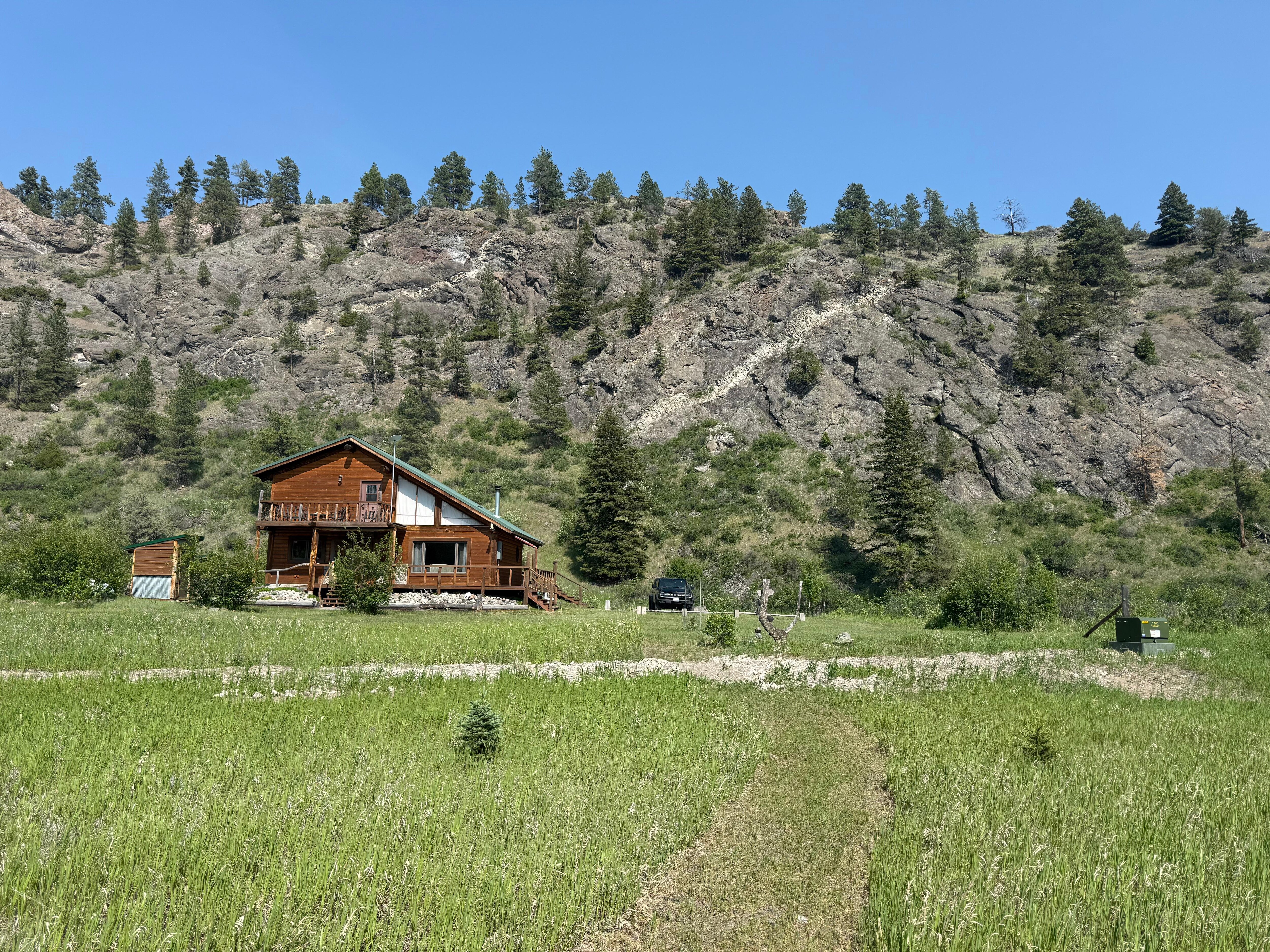 View of the cabin and adjacent cliffs