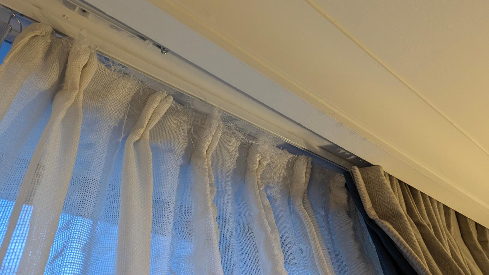 Frayed net curtains snagged the blackout curtains making them very difficult to close.