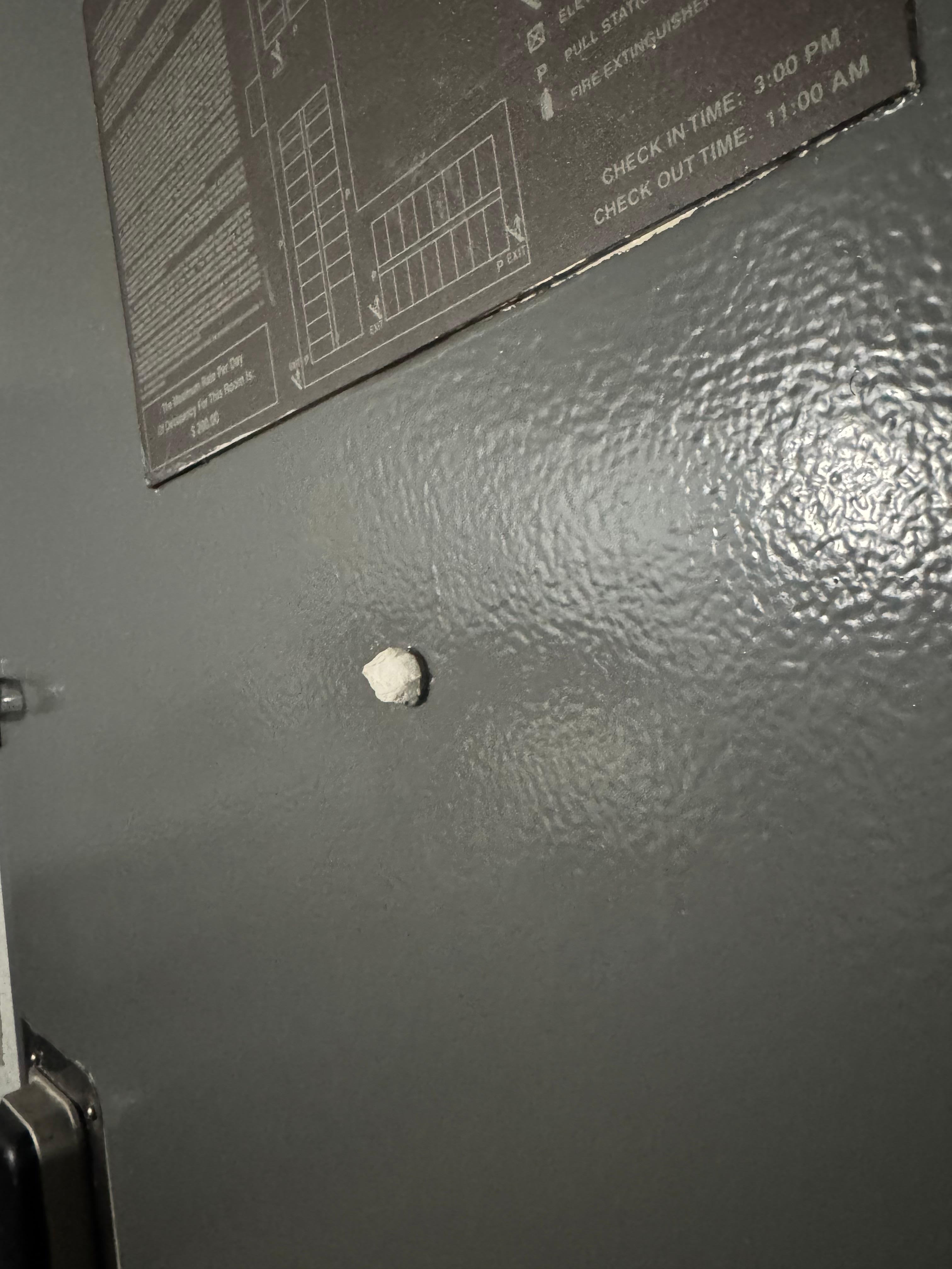 Peep hole with toilet paper in it. 