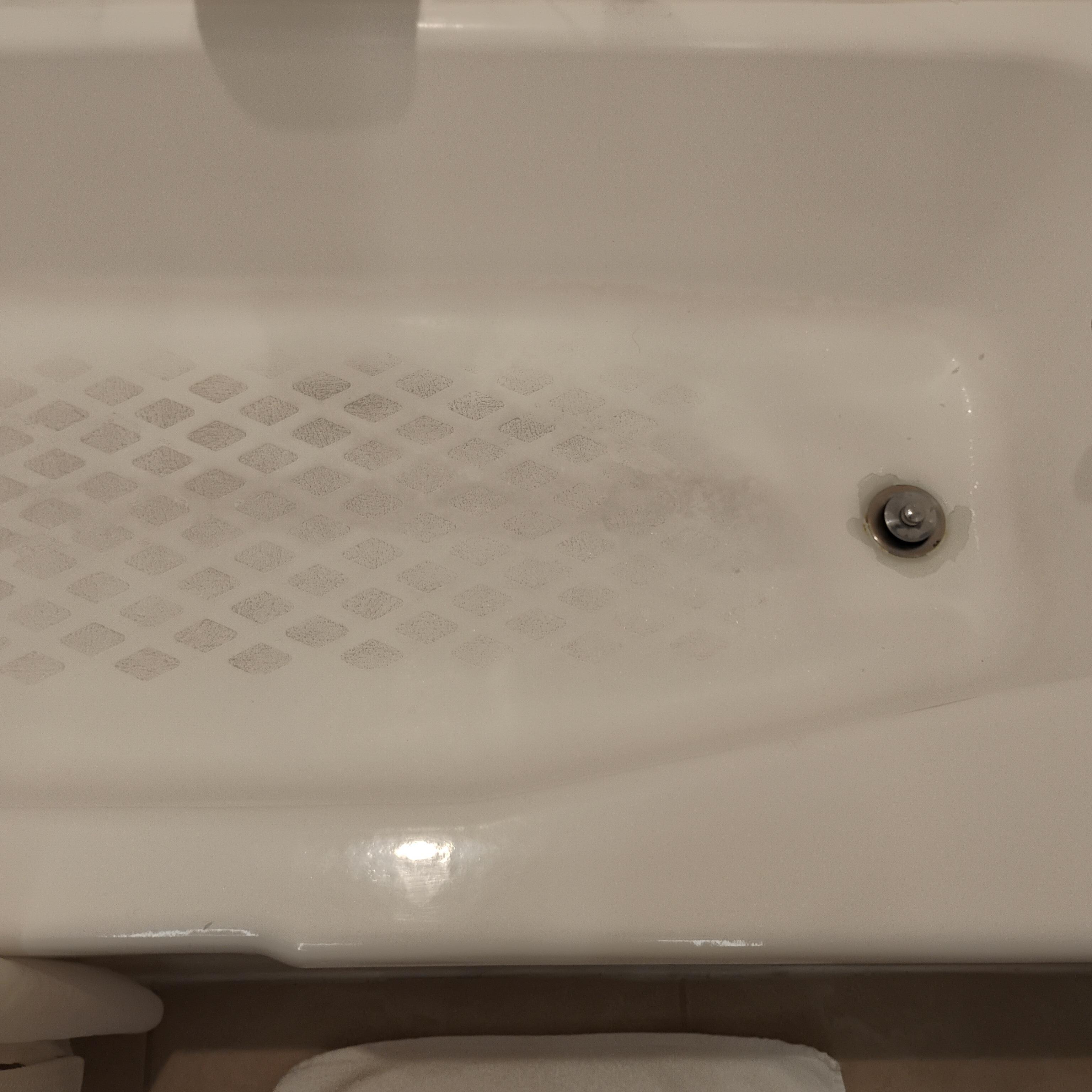 Filthy tub with black hairs and plugged drain. Horrible !