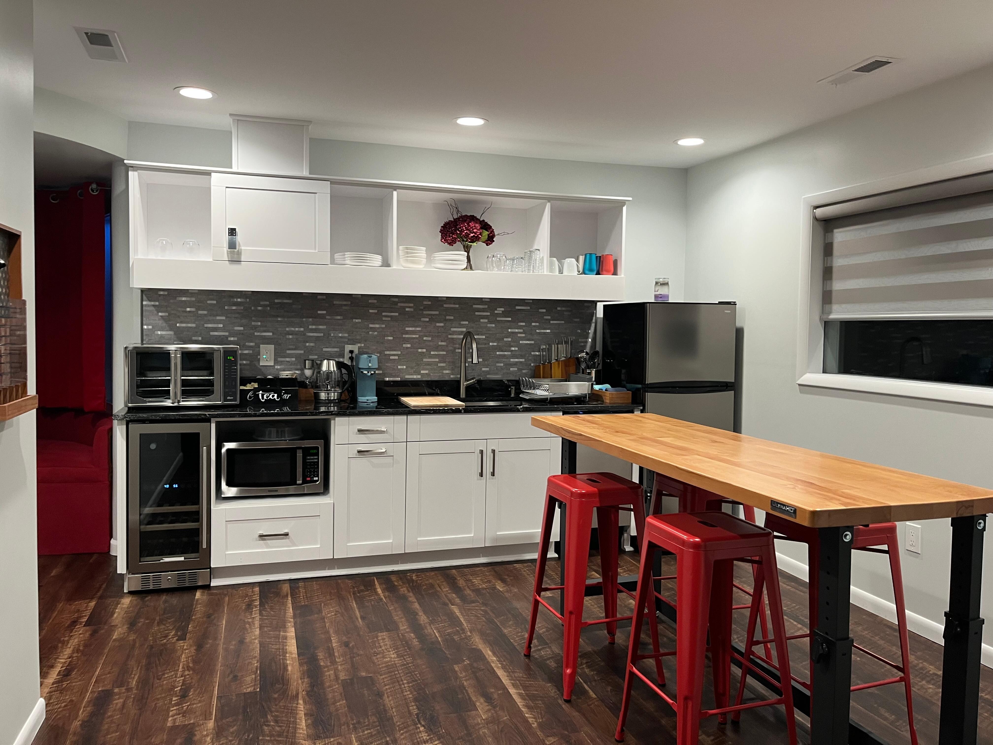 Kitchen with wine fridge, counter oven, microwave, and portable induction cooktop for stovetop option.