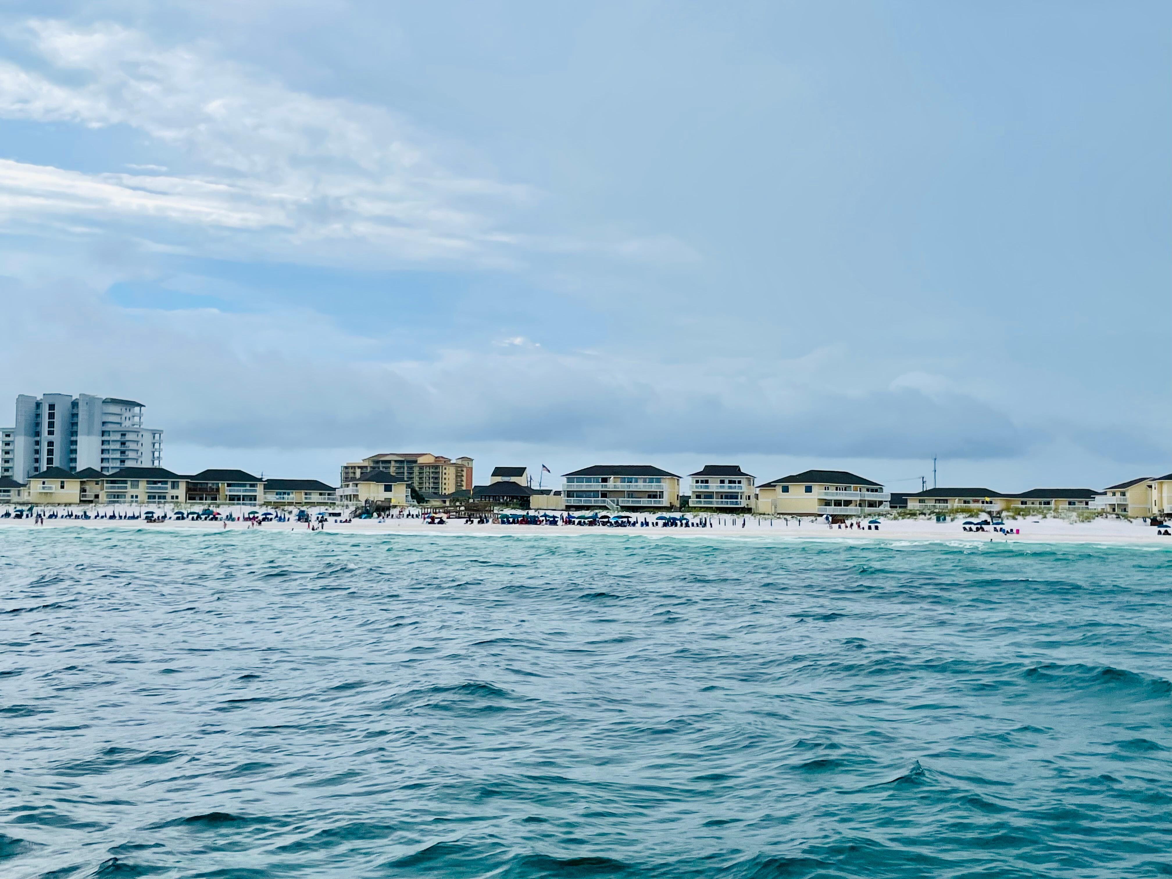 A view of the private beach access for Sandpiper Cove from our Seablaster Dolphin Cruise boat. So much fun to see so many dolphins!