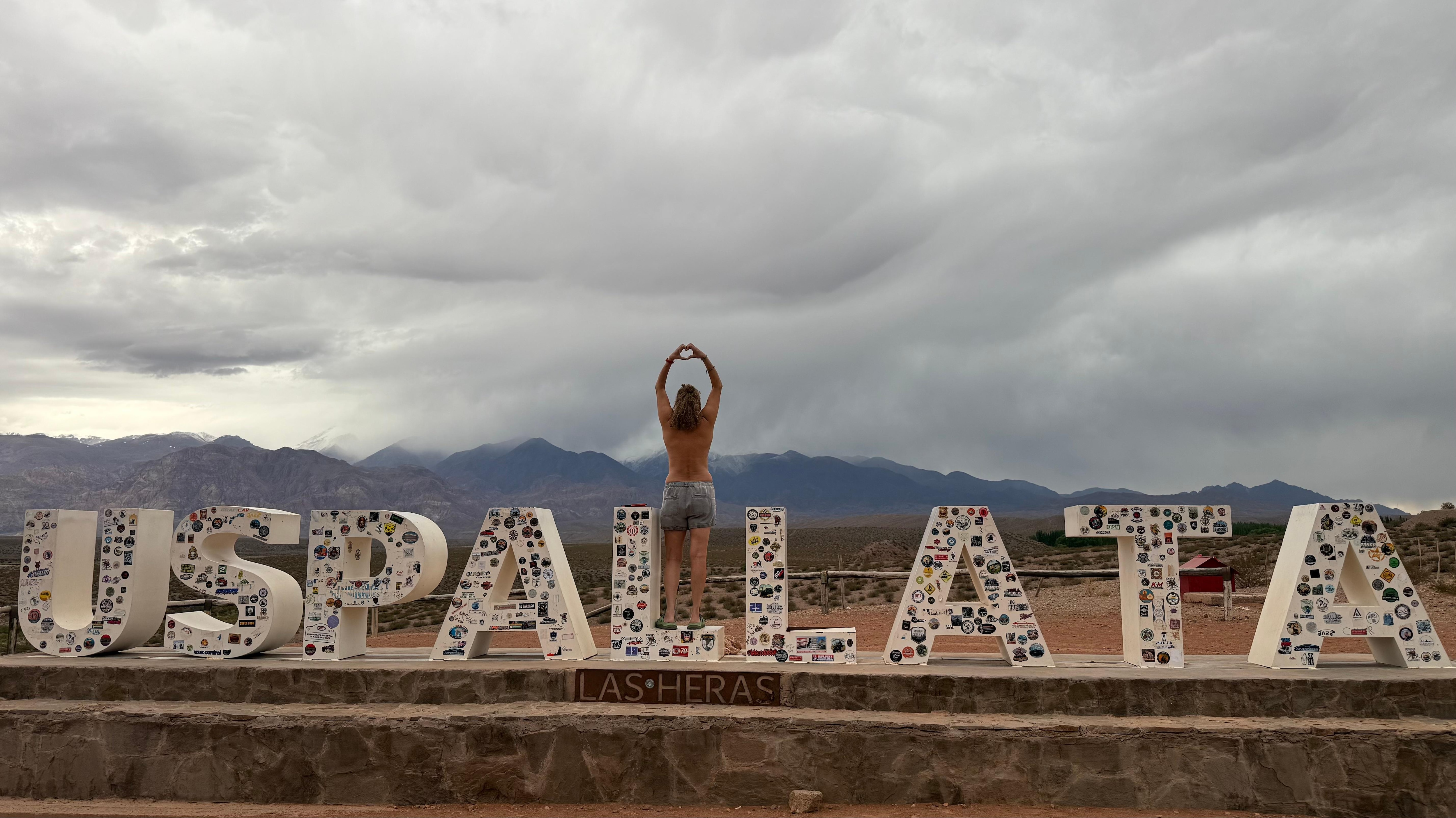 Coming into town, making the heart sign.