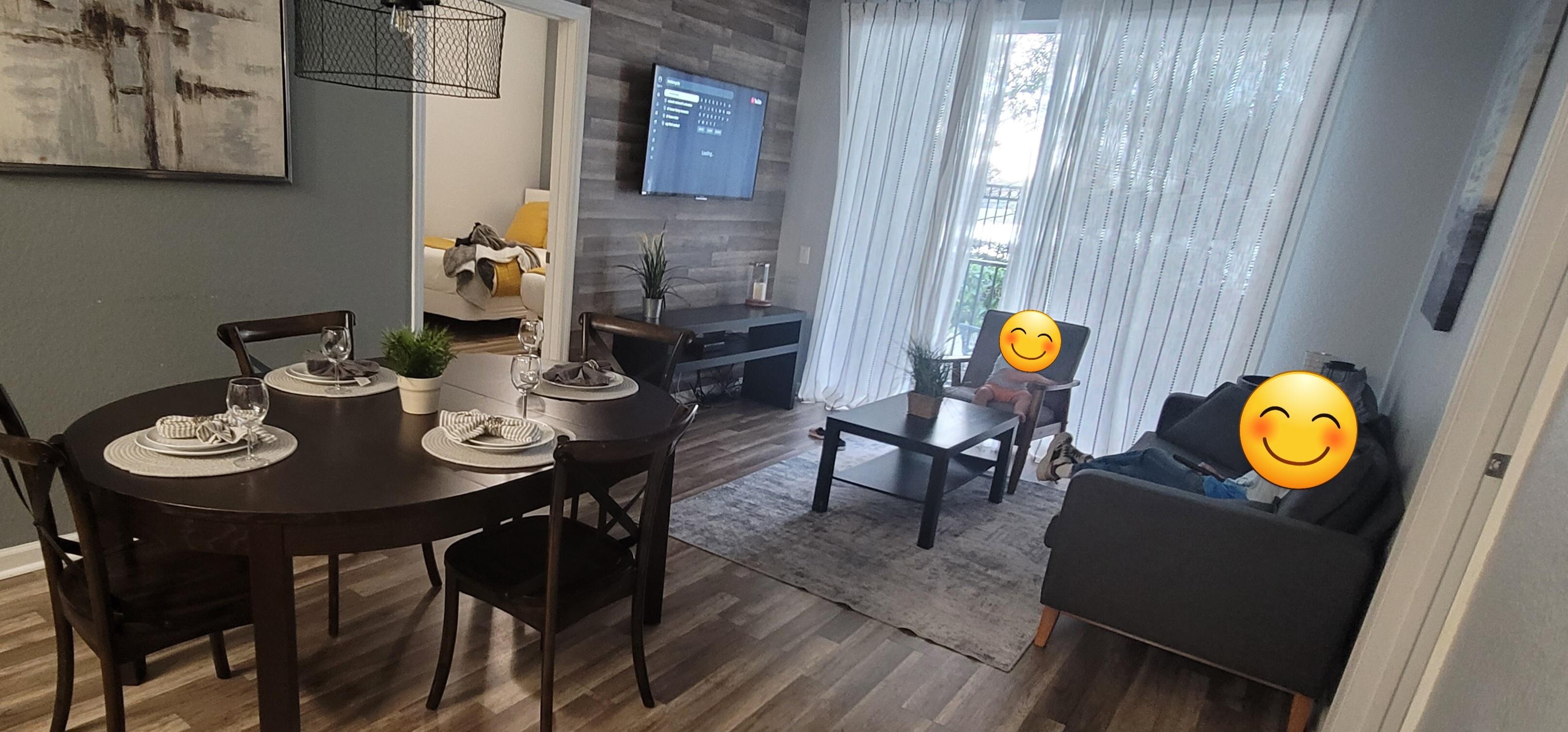 Dining table with living area. The open door leads to the 2 full beds room.